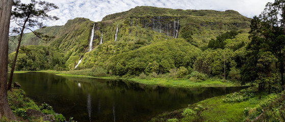 Panoramic view of the idyllic Poço da Ribeira do Ferreiro. Several waterfalls sprouting from the...