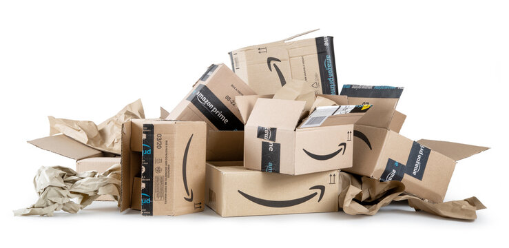 Amazon Prime cardboard boxes, pile of open packaging isolated on white background.