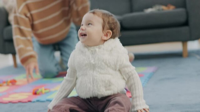 Happy, baby and mother playing while crawling on the floor in the living room with a smile, laughing and happiness. Learning, bonding and family fun together with energy in the lounge, home or house