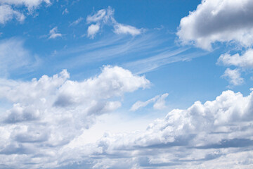 Fototapeta na wymiar Cumulus clouds blown by the wind across the sky background.