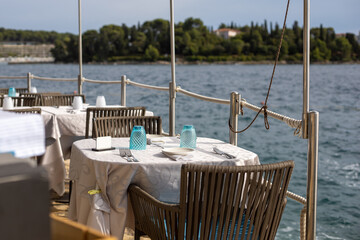 close up of table setting at open-air restaurant on beach