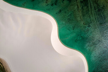 White sand dunes among lakes with blue water, aerial view
