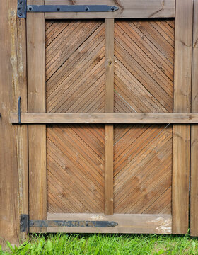 Wooden brown arch gate door, green grass