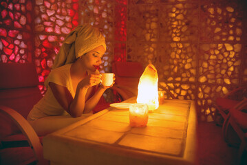 Beautiful woman enjoying salt therapy and beauty treatment in beauty spa