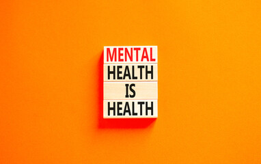 Mental health psychological symbol. Concept words Mental health is health on wooden blocks on a beautiful orange table orange background. Psychological mental health concept.