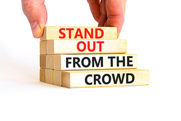 Stand out from the crowd symbol. Concept words Stand out from the crowd on wooden blocks on...