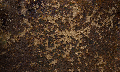 Rusty metal background. Corrosion of metal on the wall surface. Photo of antique armor from a cannon.