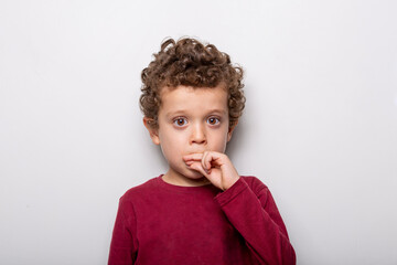 boy with brown eyes and curly hair on a white background