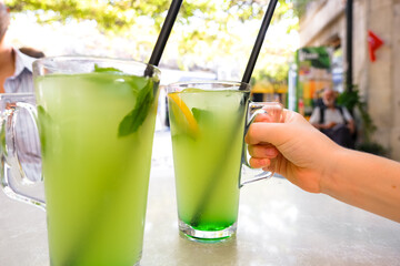 Fresh lemonade or mojito cocktail with mint on the table.