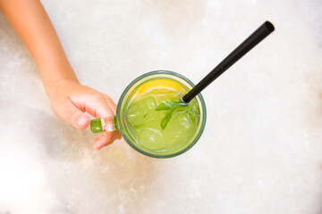 Fresh lemonade or mojito cocktail with mint on the table.