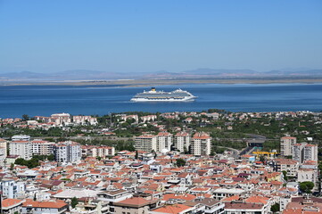 Obraz premium Izmir, Turkey - September, 06, 2022: Aerial view of the cruise ship which is arriving to Port of Izmir. It is the one of the busiest port of Turkey in the Aegean sea.
