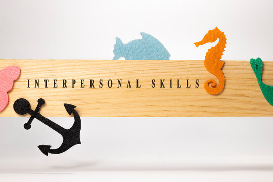 interpersonal skills written on a wooden patterned surface. Education and child psychology