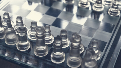 Chess game. Chess pieces made of glass. Rivalry concept. Selective focus included.