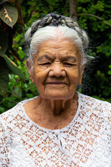 Mexican grandmother smiling with her eyes closed.