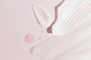 Sample beauty products for facial skin care on pink background. Cleanser foam, tonic, oil serum...