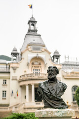 Fototapeta na wymiar Dimitrie Gika statue and Sinaia casino in Romania
