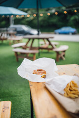 outdoor table on green astroturf with cheeseburger, French fries