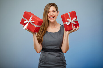 Happy woman in business dress holding two gift boxes. isolated female studio portrait.