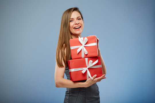 Happy business woman holding red gift boxes.