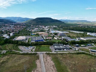 Fototapeta premium Panoramic aerial drone view of the Industrial Zone of Soultz-Haut-Rhin near Guebwiller, at the entrance of the Florival valley on a sunny summer day