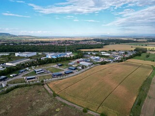 Panoramic aerial drone view of the Industrial Zone of Soultz-Haut-Rhin near Guebwiller, at the entrance of the Florival valley on a sunny summer day