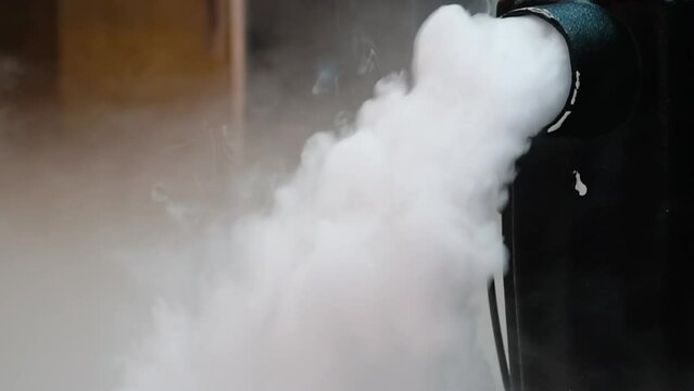 Smoke created with an electric fog machine on an empty stage. Smoke machine on a stage