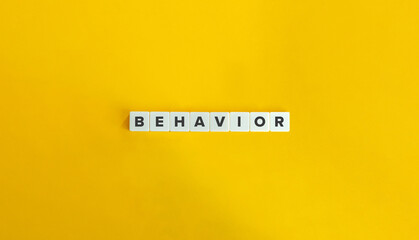 Behavior Word on Block Letter Tiles on Yellow Background. Minimal Aesthetics.