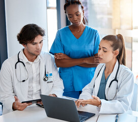 Teamwork, doctors and collaboration on laptop during a meeting in a conference room. Diverse...