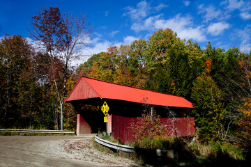 Covered bridge found on a country road near Stowe, Vermont, USA on a beautiful autumn day
