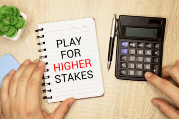 text play for higher stakes on white paper. - obrazy, fototapety, plakaty