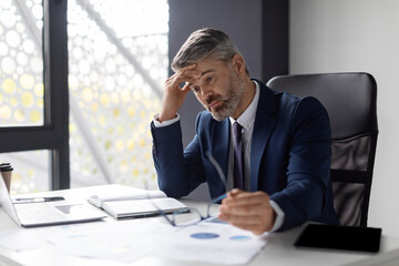 Entrepreneurship Crisis. Depressed Middle Aged Businessman Sitting At Workplace In Office
