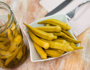 Homemade organic marinated pickled okra on a ceramic plate, portuguese snack