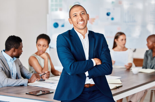 Leadership, success and teamwork, a businessman in a meeting in an office boardroom, with a smile. Diversity, collaboration and working together, proud team leader with support for staff and partners