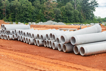 set of new pipes stacked on construction site.