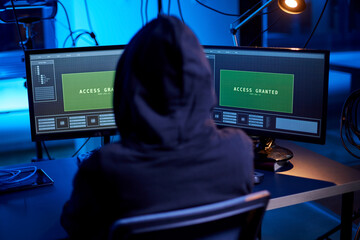 cybercrime, hacking and technology concept - hacker in dark room breaking security system or using...
