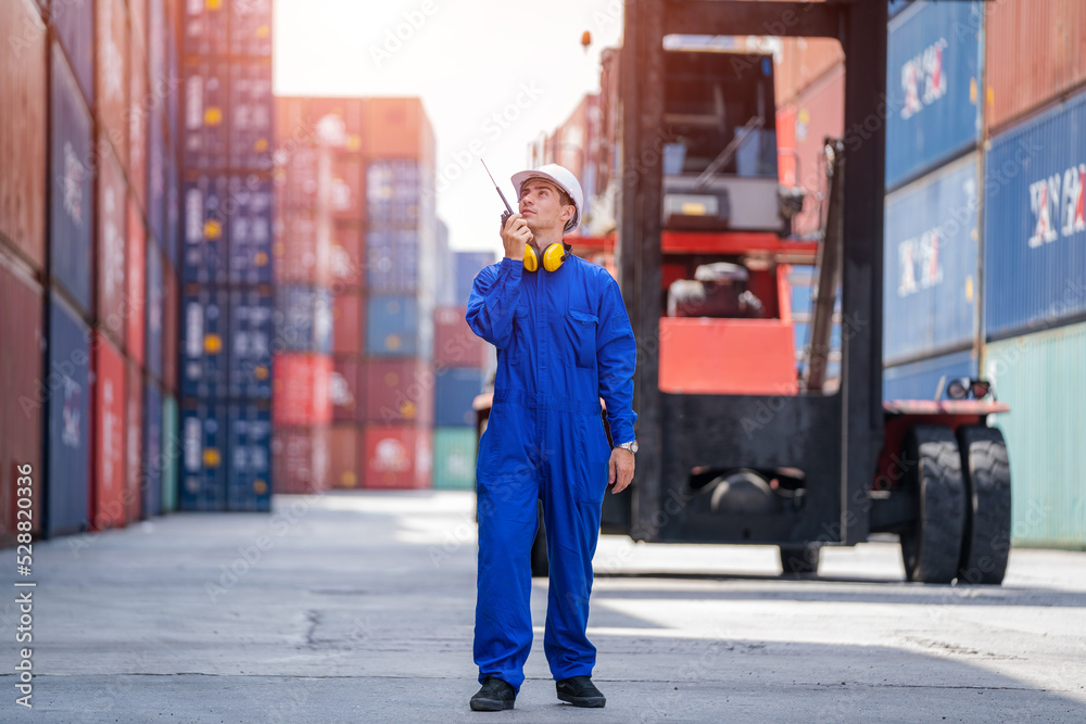 Poster Engineer working in shipping container in Container Terminal,Container in export and import business and logistics.