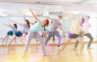 Fototapeta na wymiar Active teens learn new dance moves in dance studio