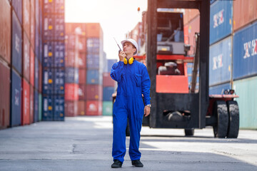 Engineer working in shipping container in Container Terminal,Container in export and import business and logistics.