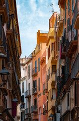 Fototapeta na wymiar Narrow street with colorful buildings in the city of Palma de Mallorca, Spain, on the island of Mallorca. 