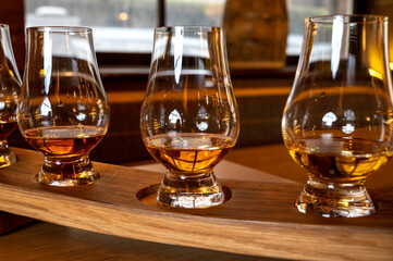 Flight of single malt scotch whisky in glasses served in whiskey bar in Edinburgh, UK