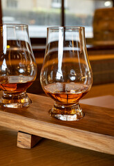 Flight of single malt scotch whisky in glasses served in whiskey bar in Edinburgh, UK