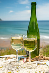 Tasting of txakoli or chacolí slightly sparkling very dry white wine produced in the Spanish Basque Country, served outdoor with view on Bay of Biscay, Atlantic Ocean.