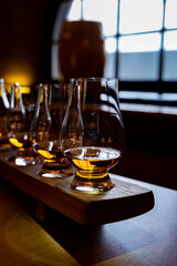Flight of single malt scotch whisky in glasses served in whiskey bar in Edinburgh, UK