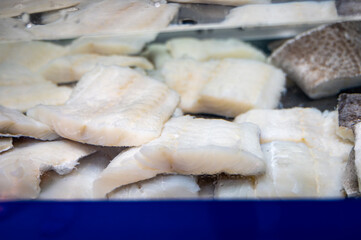 White salted and dried bacalao codfish is watertank, traditional Spanish food on display in fish shop