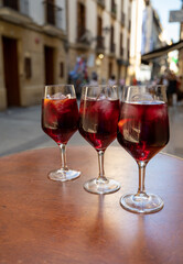 Glasses of cold sangria wine served outdoor in bar with view on old street in San Sebastian, Basque Country, Spain