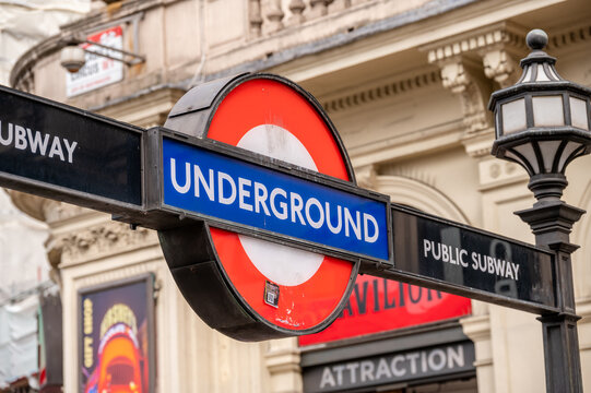 London, UK - August 22, 2022: Low angle view of Underground sign in Picadilly Circus against sky a sunny day