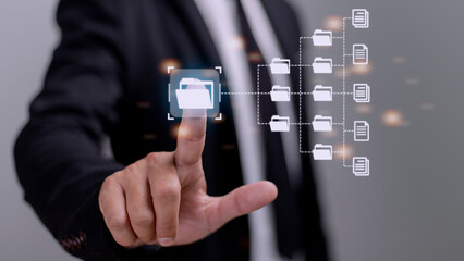 Document Management System (DMS) being setup by IT consultant working on laptop computer in office. Software for archiving, searching and managing corporate files and information