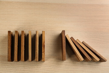 Domino tiles on wooden background, flat lay