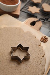 Homemade Christmas biscuits. Dough and cookie cutter on table, closeup