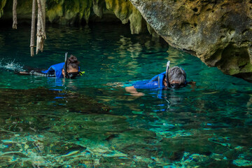 Some people is snorkeling on a cenote in Cancun Mexico - obrazy, fototapety, plakaty